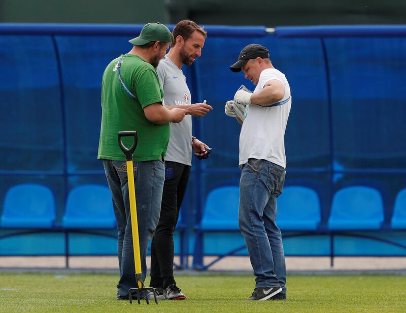 England manager Gareth Southgate signs his autograph for ground staff during training. REUTERS / Lee Smith