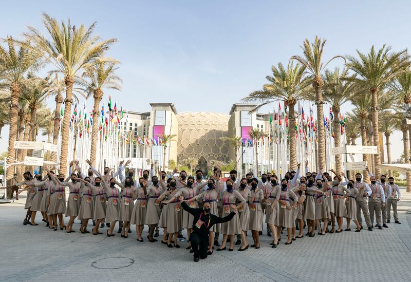 Members of staff pose for a picture before the Expo 2020 Dubai opening ceremony. Photo: Chris Whiteoak / The National
