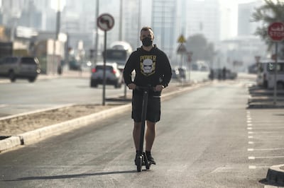 SHARJAH, UNITED ARAB EMIRATES. 01 MARCH 2021. A man rides an electric scooter down a one way road in the Al Quoz district of Dubai. (Photo: Antonie Robertson/The National) Journalist: None. Section: National.