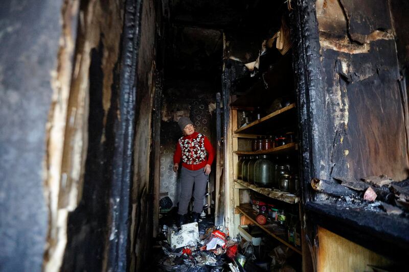 A woman searches for household items in her burnt-out apartment, recently hit by shelling in Donetsk. Reuters