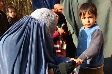Afghan health workers administer polio vaccinations to children in Kandahar, Afghanistan, in December 2019. Muhammad Sadiq / EPA