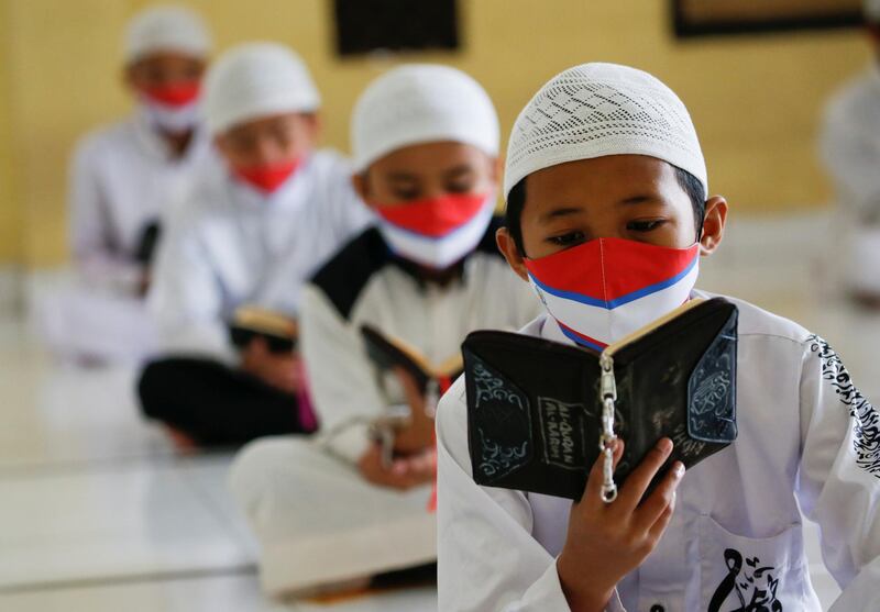 Muslim students wearing face masks practice social distancing while reading Quran at Daarul Qur'an Al Kautsar boarding school mosque in Bogor, West Java province, Indonesia. Reuters