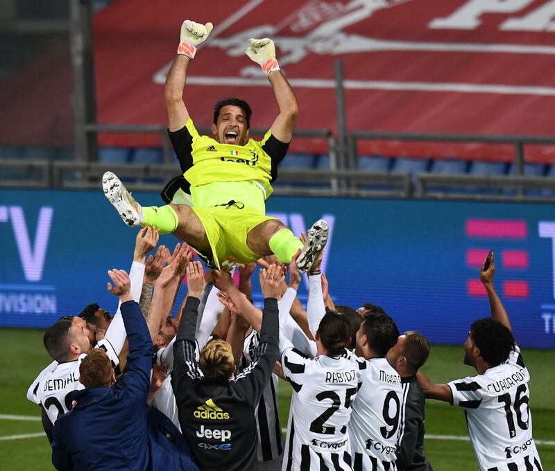 Gianluigi Buffon is lifted by teammates after the match. Getty