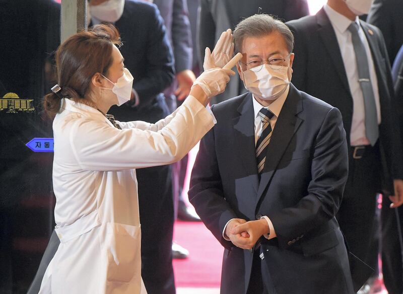 South Korean President Moon Jae-in gets temperature tested upon his arrival at the National Assembly in Seoul, South Korea, February 28, 2020.    Yonhap via REUTERS   ATTENTION EDITORS - THIS IMAGE HAS BEEN SUPPLIED BY A THIRD PARTY. SOUTH KOREA OUT. NO RESALES. NO ARCHIVE.