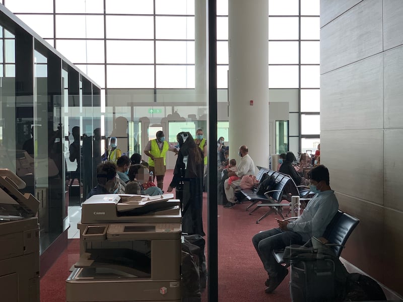 Passengers from RAF flight ZZ172 arrive at Al Maktoum International Airport.