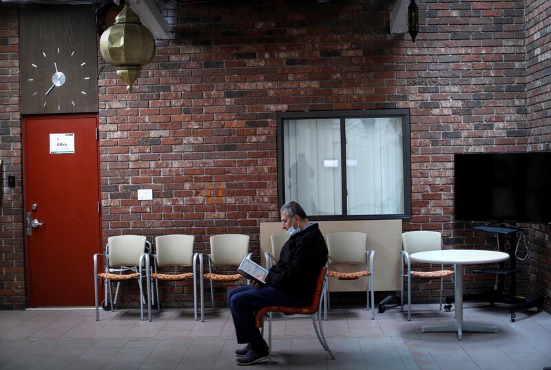 Ahmed Al Fateh sits alone reading the Quran shortly before midday prayers in Patterson, New Jersey, US. Reuters