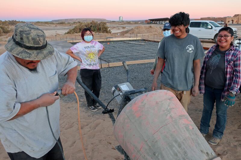 Francisco Mata Kira Nevayaktewa, Quintin Nahsonhoya and Felicia Mata help lay a concrete foundation for a skate ramp. AP