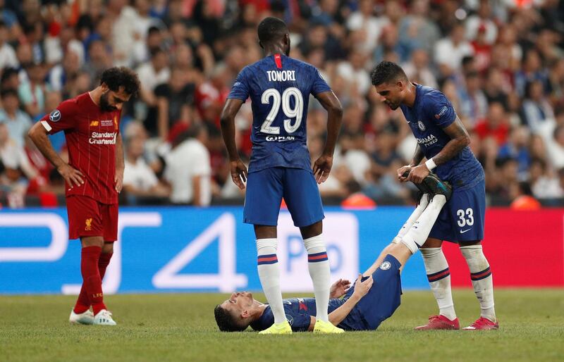 Liverpool's Mohamed Salah looks on as Chelsea's Emerson Palmieri helps Jorginho with an injury. Action Images via Reuters