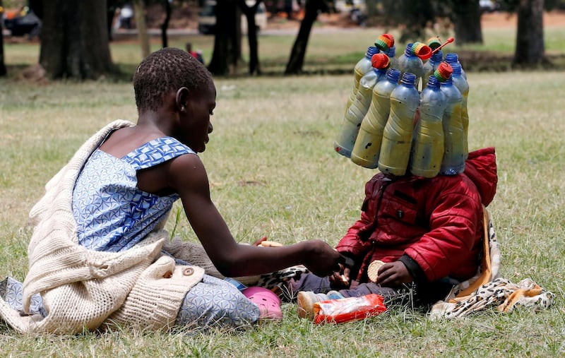 A child wears plastic bottle waste provided by climate and environmental activists during a protest in Nairobi, Kenya. Reuters