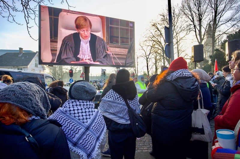 Pro-Palestinian demonstrators watch proceedings. Bloomberg