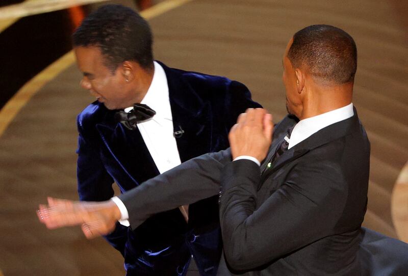 Will Smith (R) hits Chris Rock as Rock spoke on stage during the 94th Academy Awards in Hollywood, Los Angeles. Reuters