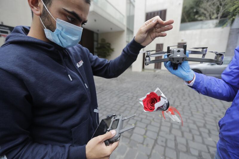 Young men prepare roses to be delivered via drone to women on Mother's day, in Haret Sakher near the coastal city of Jounieh, north of the capital Beirut, as people remain indoors in an effort to limit the spread of the novel coronavirus.  Three young Lebanese came up with the idea of delivering roses attached to drones, offered to mothers by their children as a surprise gift. The funds collected from this initiative will be donated to the Lebanese Red Cross to help  fight against the CIVID-19 pandemic. AFP