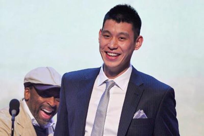 Director Spike Lee (L) and New York Knicks basketball player Jeremy Lin interact on stage during the 16th annual Webby Awards in New York May 21, 2012. REUTERS/Stephen Chernin (UNITED STATES - Tags: ENTERTAINMENT SCIENCE TECHNOLOGY SPORT)