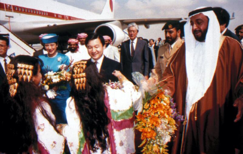 Two girls offer flowers to the Japanese Crown Prince Naruhito, centre, and his host Sheik Khalifa bin Zayed Al Nahyan at Abu Dhabi International Airport Monday, Jan. 23, 1995. The Prince and his wife Princess Masako (2nd left) are on a four-day visit, they arrived from Kuwait and their Middle East tour will also take them to Jordan complementing their November tour to Saudi Arabia and other Arab countries. (AP Photo/Shaweesh)