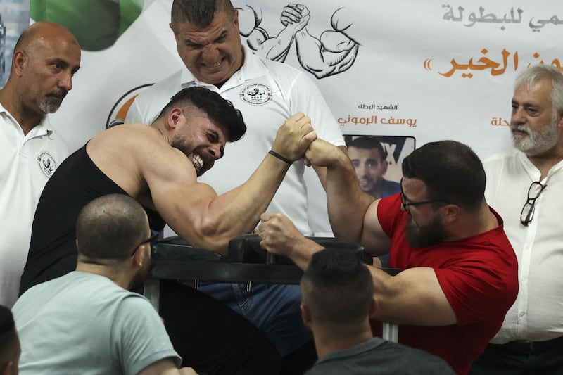 Palestinians take part in a two-day arm wrestling championship in Rammun village, east of Ramallah, in the West Bank.