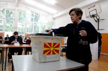 A woman casts her ballot in the presidential run-off election at a polling station in Skopje, North Macedonia. AP