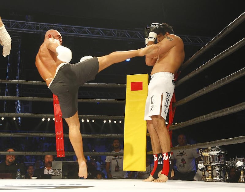 Jaideep Singh of India, right, takes evasive action as Fatih Ulusoy of Turkey put in an action-packed performance during their super heavyweight bout of the Global Fighting Championship in Dubai. Jeffrey E Biteng / The National 