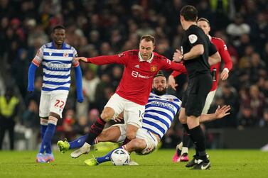 Manchester United's Christian Eriksen (left) and Reading's Andy Carroll battle for the ball during the Emirates FA Cup fourth round match at Old Trafford, Manchester. Picture date: Saturday January 28, 2023.