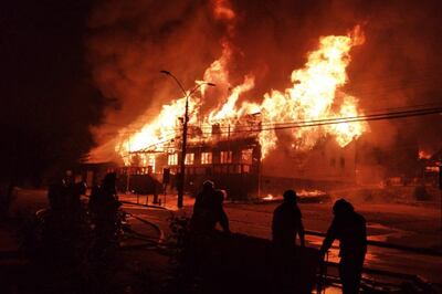 epa08992380 View of a fire in the town facilities during riots in Panguipulli, Chile, 05 February 2021 (issued 06 February 2021). Riots took place in Panguipulli after a police agent allegedly shot a street juggler in a routinary operation.  EPA/ALICIA CACECERES / ATON CHILE