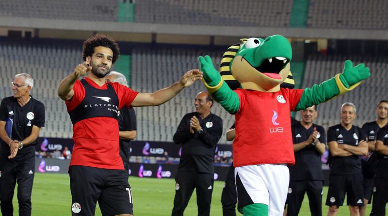 Mohamed Salah waves to the fans with the team mascot. Khaled Elfiqi / EPA