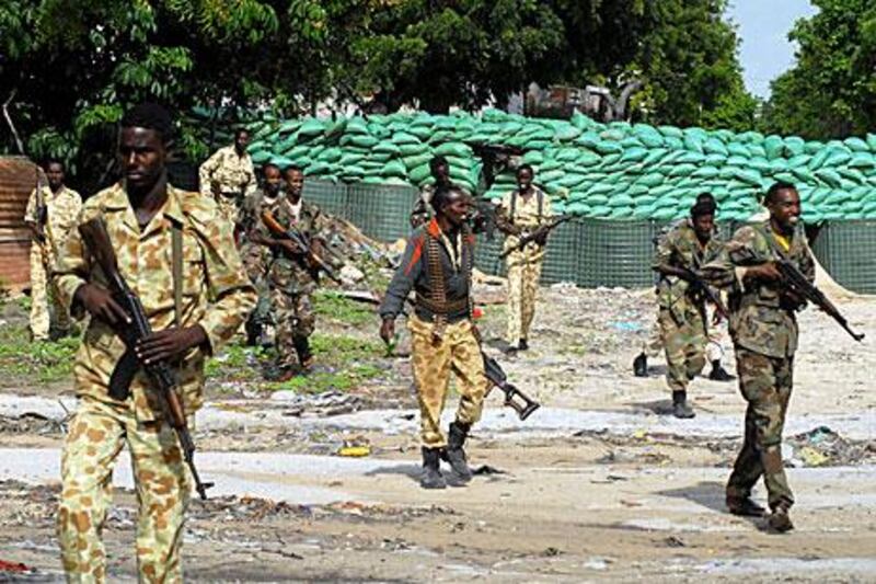 Somali government soldiers leave their barracks yesterday to take control of positions abandoned by the militant group Al Shabab, which appears to be pulling out from the city. The government called the retreat a “golden victory”, but the militants said it was a tactical withdrawal.