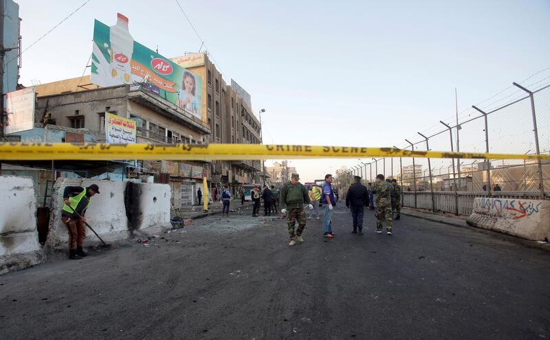 Iraqi security forces inspect the site of a bomb attack. Khalid Al Mousily / Reuters