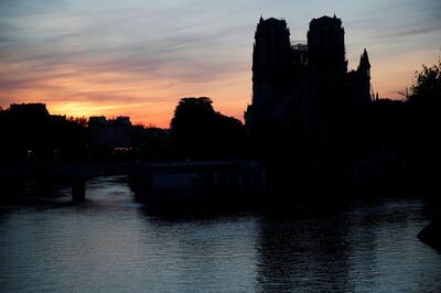 The towers of the Notre-Dame Cathedral are reflected on the River Seine at sunset, two days after a massive fire devastated large parts of the gothic structure in Paris, France, April 17, 2019.   REUTERS/Charles Platiau