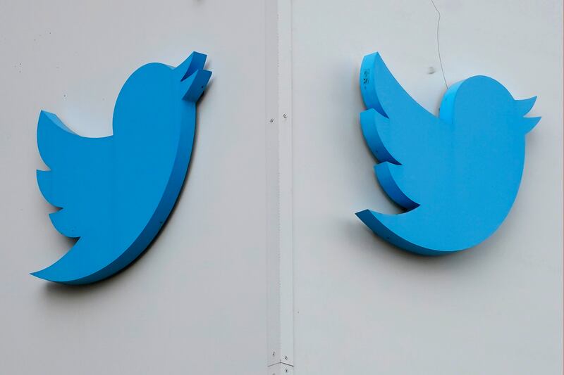 Twitter logos are displayed outside the company's offices in San Francisco. AP