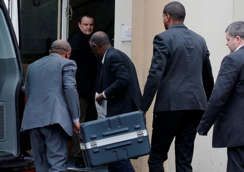 Men unload a case containing the black boxes from the crashed Ethiopian Airlines Boeing 737 MAX 8 outside the headquarters of France's BEA air accident investigation agency in Le Bourget, north of Paris, France, March 14, 2019.   REUTERS/Philippe Wojazer