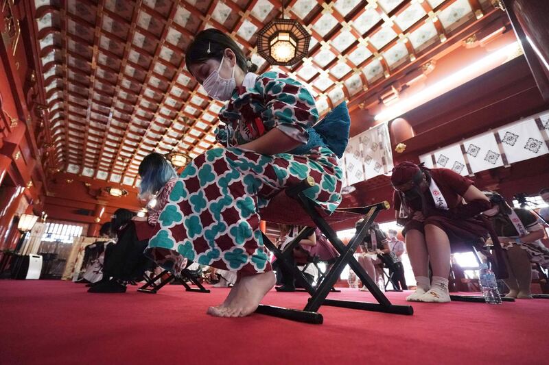 Employees from several maid-themed cafes of Akihabara pray during a prayer-meeting for protection from Covid-19 and for a thriving business at the Kanda Myojin shrine in Tokyo. AP Photo