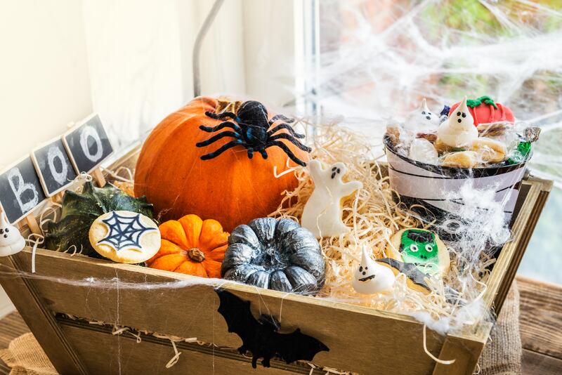 Candles, mini pumpkins and Halloween-themed sweets are frequently added to boo baskets. Getty Images