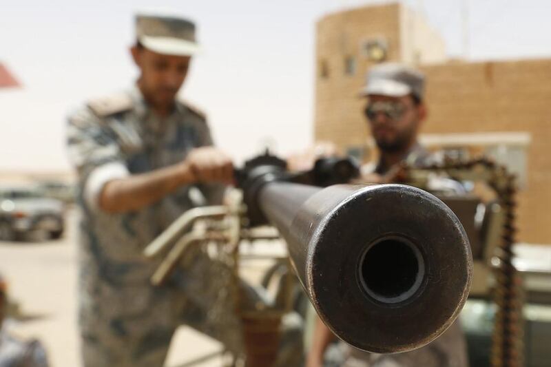 Saudi border guards hold a machine gun mounted on a military truck positioned on Saudi Arabia's northern borderline with Iraq on July 14, 2014. Three mortar bombs landed inside Saudi Arabia last week close to its northern border with Iraq, where Islamist militants have grabbed land in a lightning advance, officials said. Faisal Al Nasser / Reuters