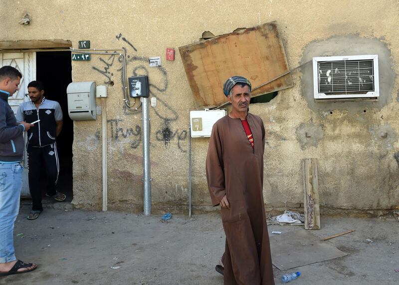 An Egyptian labourer stands outside a home hit by falling shrapnel from Yemeni rebel missiles that were intercepted over Riyadh. Fayez Nureldine / AFP