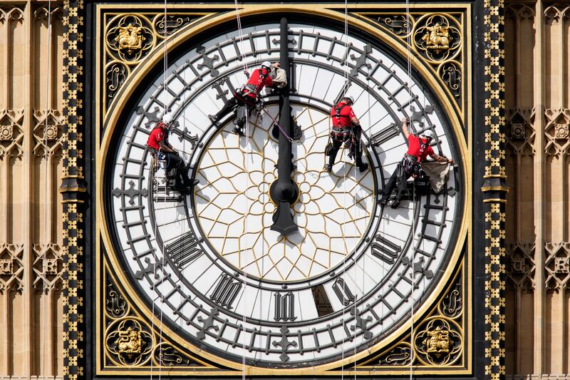 Workers clean the east-facing clock face in 2014. Getty Images
