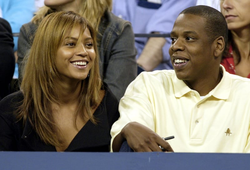Beyonce and Jay-Z watch the women's semifinal match between Kim Clijsters of Belgium and Lindsay Davenport of the United States at the 2003 US Open in Flushing Meadows, New York, September 5, 2003. Reuters