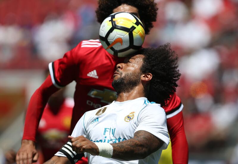 Real Madrid defender Marcelo, right, heads the ball. Beck Diefenbach / AFP