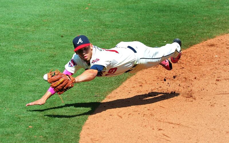 Andrelton Simmons #19 of the Atlanta Braves is unable to hold on to an 8th inning line drive against the Chicago Cubs at Turner Field in Atlanta, Georgia. Scott Cunningham / Getty Images