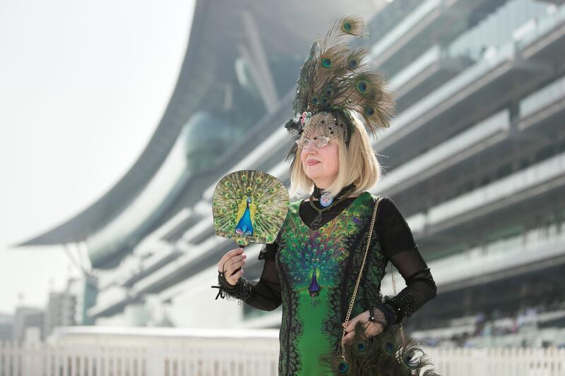 DUBAI, UNITED ARAB EMIRATES - MARCH 31, 2018. 

A woman in a peacock theme outfit at Dubai World Cup 2018.

(Photo by Reem Mohammed/The National)

Reporter: 
Section: NA