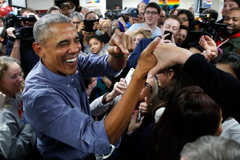 Former President Barack Obama smiles as he greets Democratic volunteers in a surprise appearance in Fairfax Station Virginia. AP