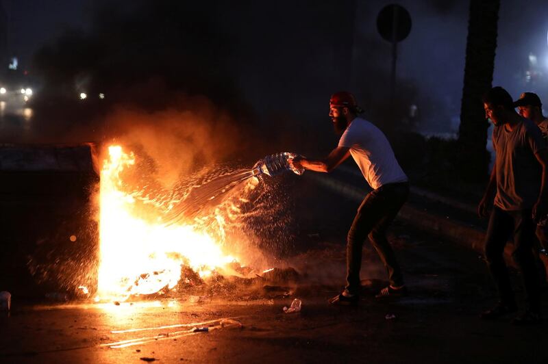 Demonstrators start a fire during a protest over deteriorating living conditions and after the Lebanese government raised subsidised bread prices, in Beirut, Lebanon. REUTERS