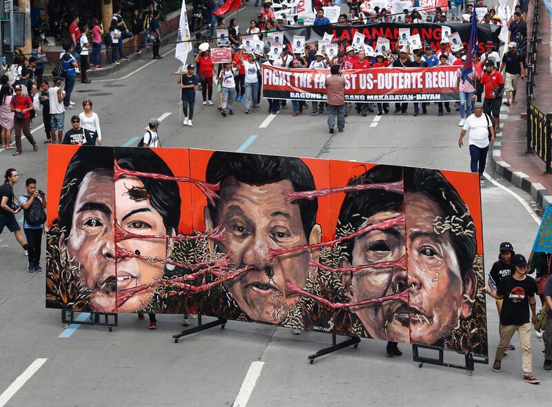 Murals of House Speaker Gloria Macapagal-Arroyo, President Rodrigo Duterte, and former dictator Ferdinand Marcos on display as Filipino protesters stage a demonstration in Manila, Philippines.  EPA
