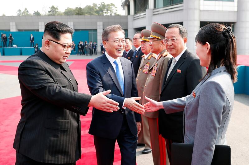 South Korean President Moon Jae-in, centre, prepares to shake hands with Kim Yo-jong, right, sister of North Korean leader Kim Jong-un. Korea Summit Press Pool via AP