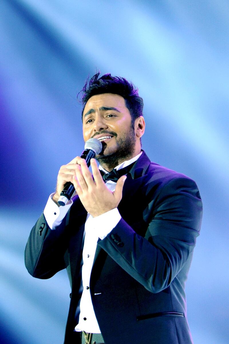 Egyptian pop sensation Tamer Hosny performs on stage in the western Saudi city of Jeddah on March 30, 2018. - Thousands of fans were taken by surprise when tickets for Hosny's first-ever Saudi concert came with the edict that dancing was "strictly prohibited". (Photo by Amer HILABI / AFP)