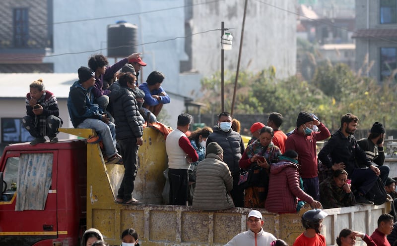 Pokhara residents watch from a distance as rescue teams work at the crash site of a Yeti Airlines ATR72 aircraft. EPA
