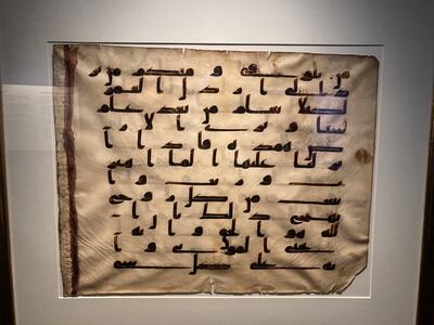 A folio from an 8th-century Quran manuscript is one of the oldest pieces in the exhibition. Razmig Bedirian / The National