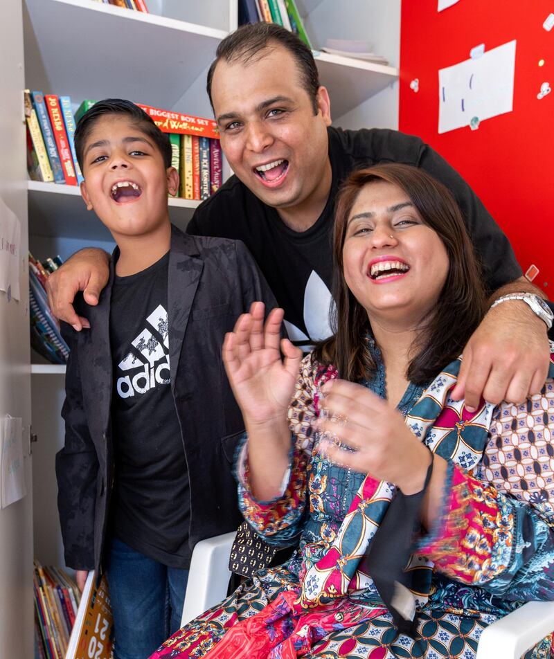 Ayaan Tariq, 7, with parents, Tariq and Moomal. He has a collection of around 300-400 books which he keeps in a cupboard. He lends these out to children free of charge. June 22, 2021. Victor Besa / The National.
Reporter: Anam Rizi for News