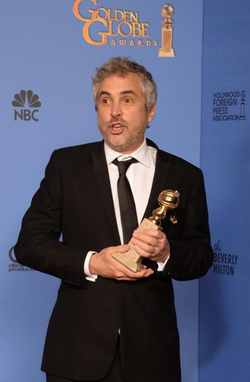 Alfonso Cuaron celebrates winning Best Director - Motion Picture for Gravity. AFP 

