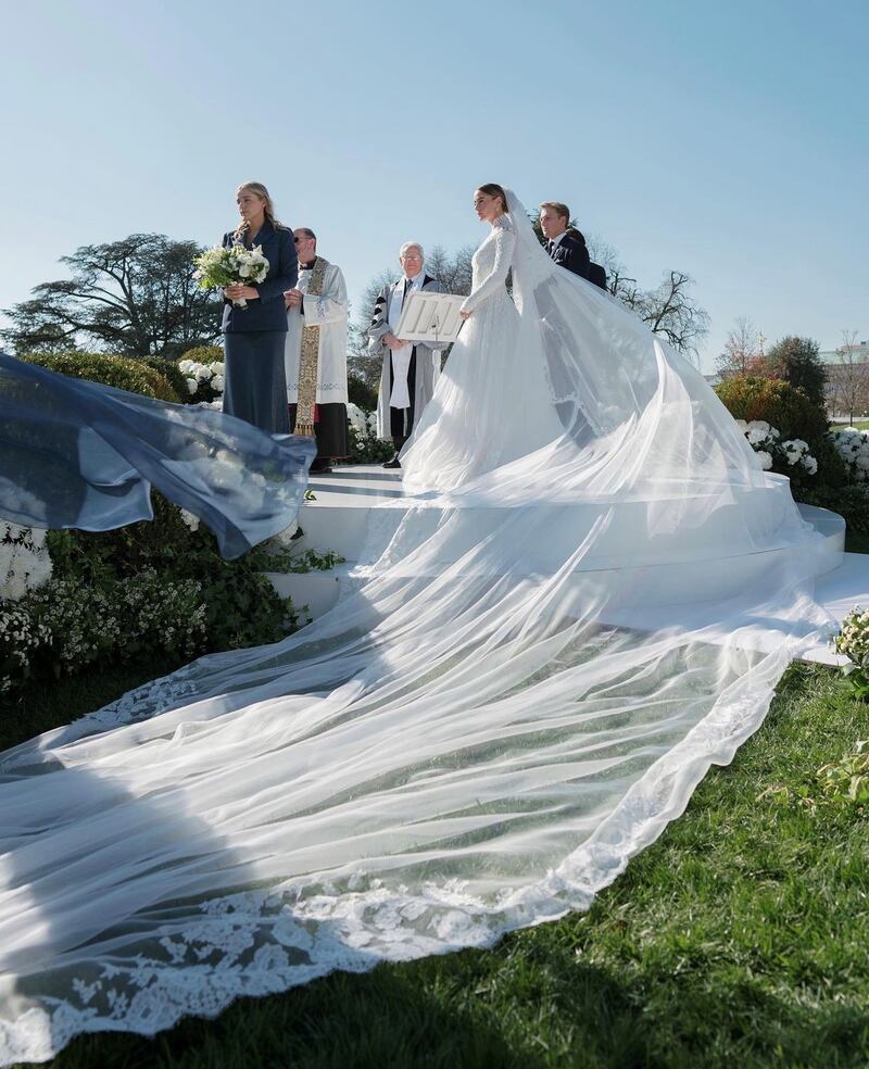 A long veil trailed behind Ms Biden as she approached the aisle to a live rendition of Bitter Sweet Symphony by The Verve. Photo: Corbin Gurkin