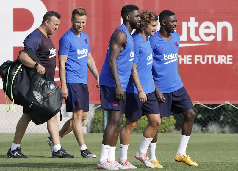 From left: Barcelona's French players Ousmane Dembele, Samuel Umtiti and Antoine Griezmann on their way to training. EPA