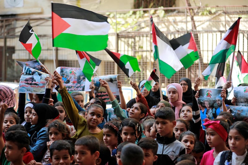 Palestinian children denouncing the killing of children in Gaza by waving banners and flags during a sit-in protest at the Shatila refugee camp in Beirut. AFP